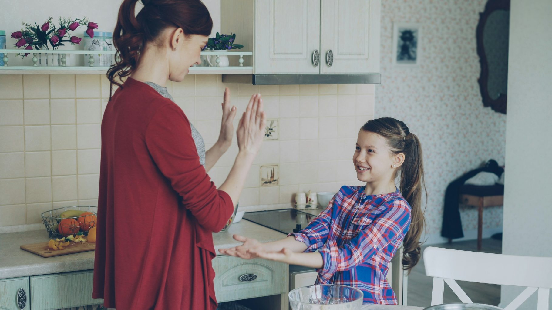Parent giving their child a high five